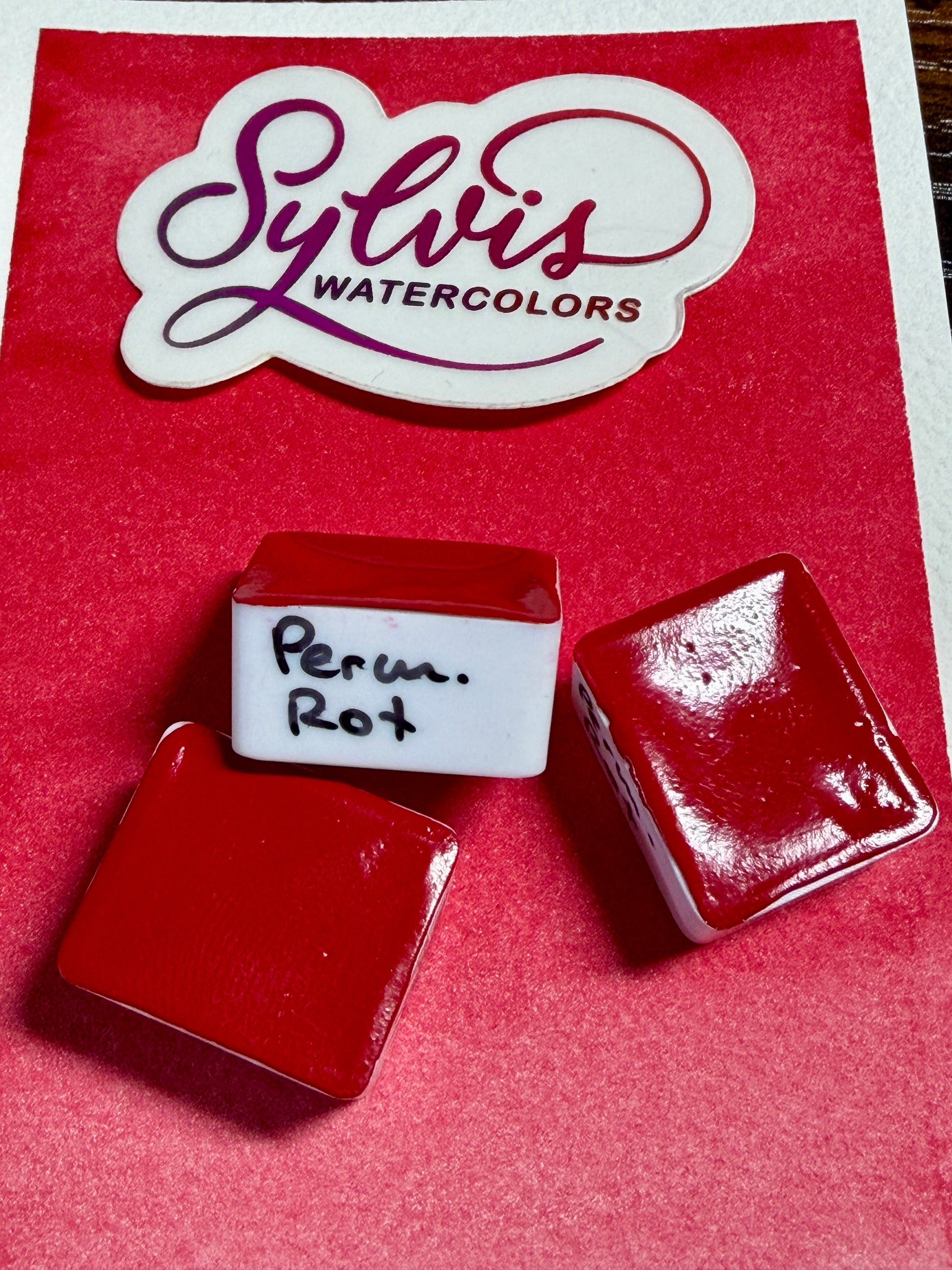 Halbe Näpfchen Permanent Rot auf Farbkarte im Hintergrund Logo Sylviswatercolors